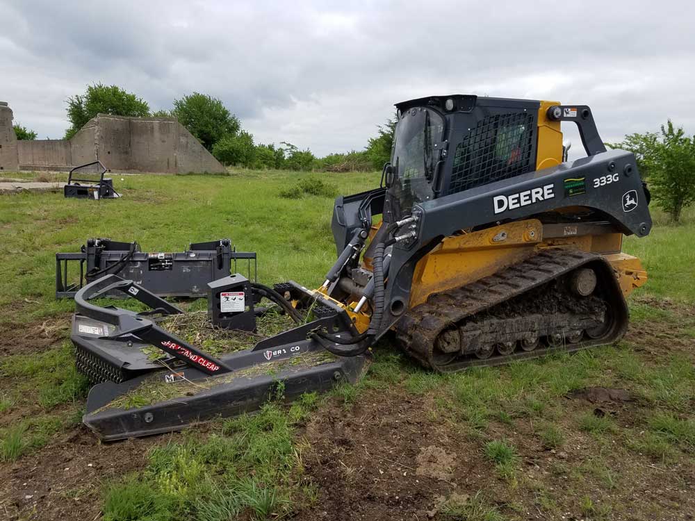 Yellow skid steer with mulching attachment