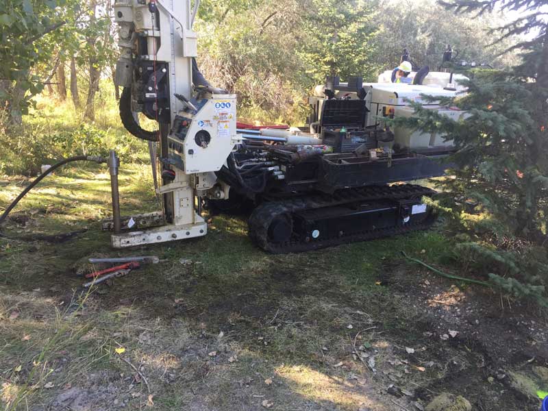 Track with injection equipment in a wooded area.